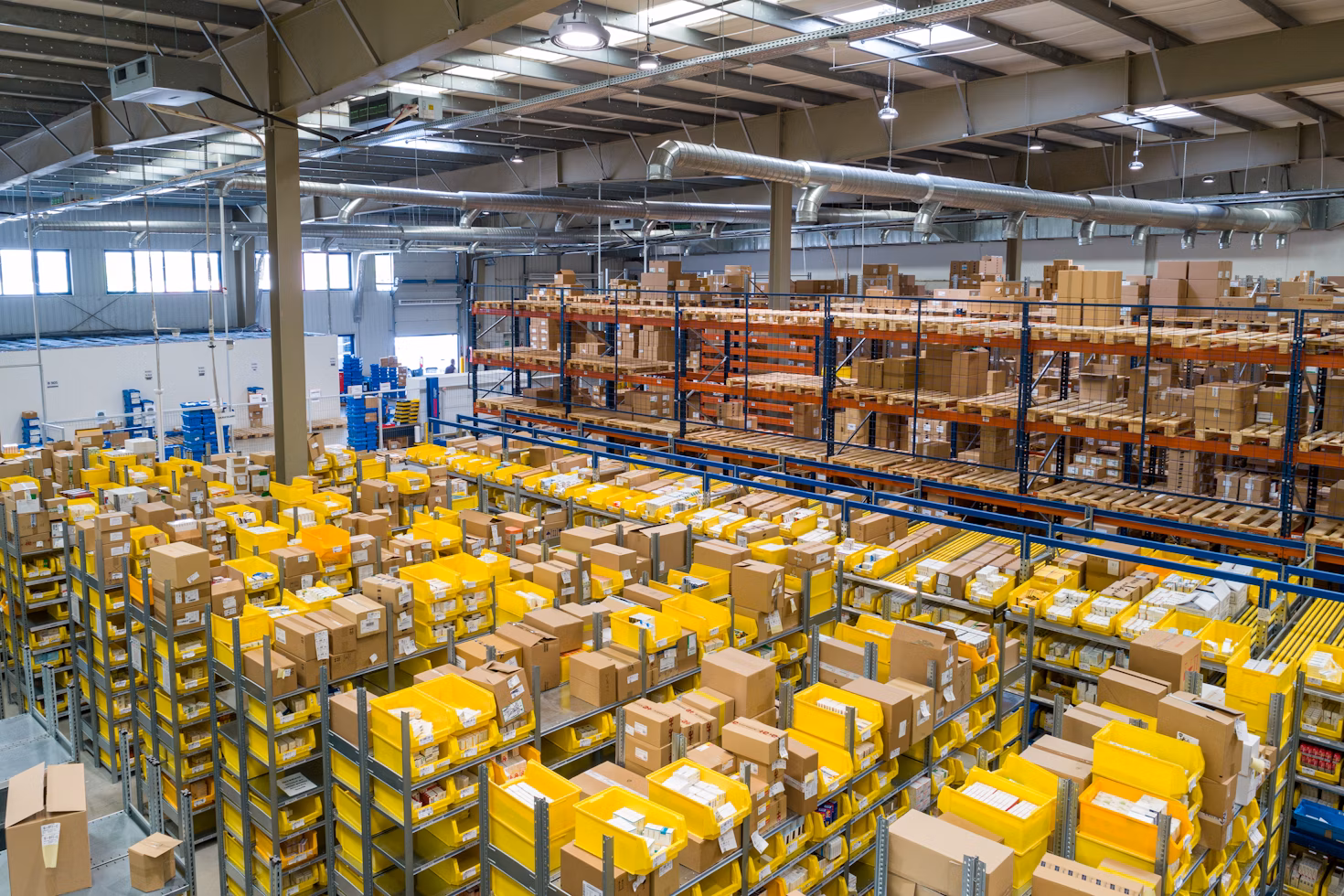 Modern automated warehouse with organized inventory shelves and yellow storage containers